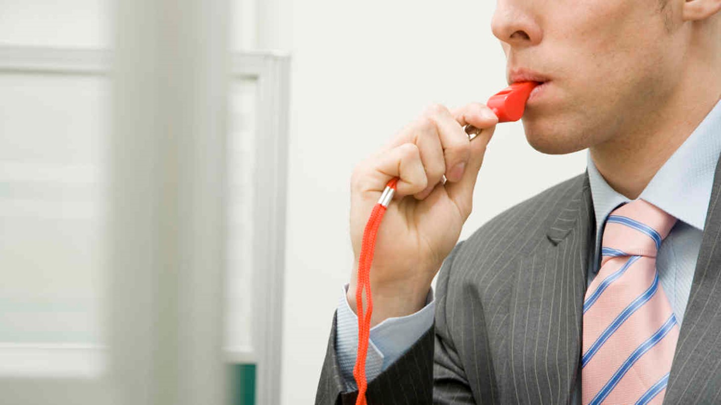 Man blowing whistle reporting scam